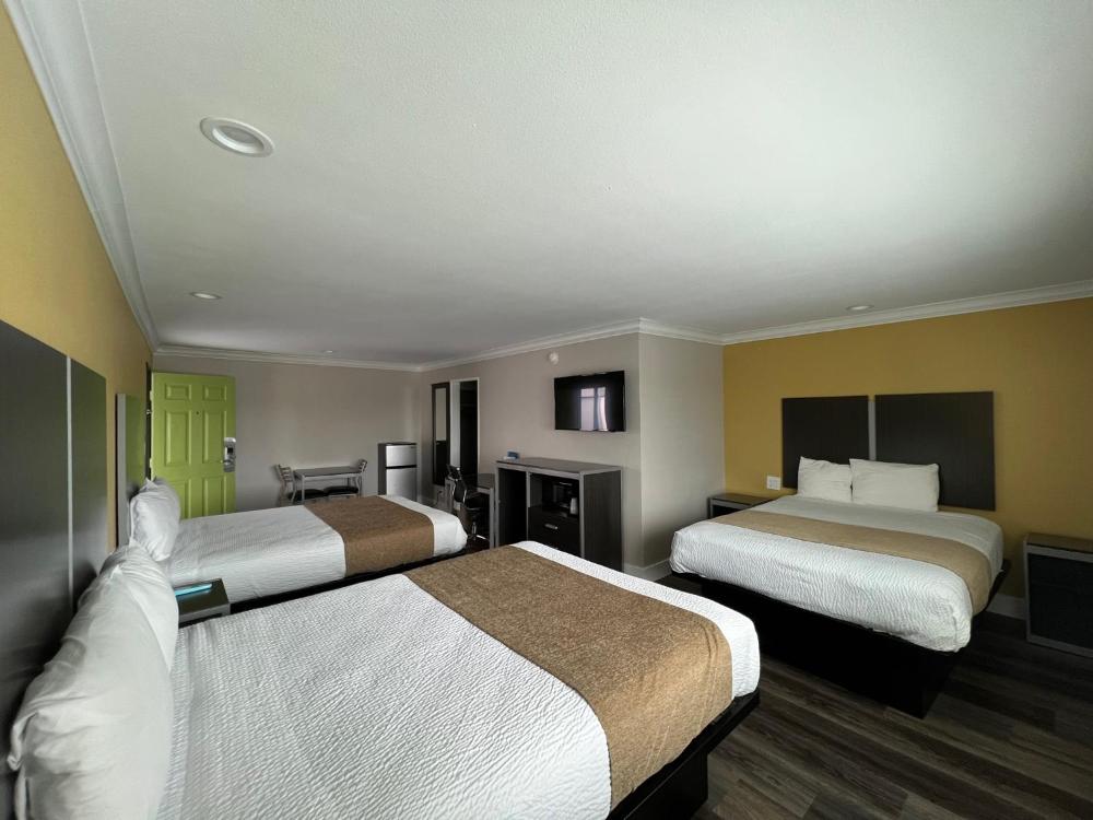 Deluxe king room with work desk, flat-screen TV and coffee station at Deluxe Inn Hawthorne near LAX airport
